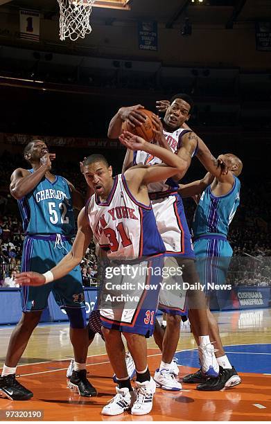 New York Knicks' Marcus Camby seizes rebound over teammate Mark Jackson as the Charlotte Hornets' Otis Thorpe and Derrick Coleman watch during the...