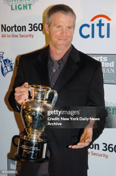 Green Bay Packers' quarterback Brett Favre holds his trophy while at Skylight Studios where Sports Illustrated magazine honored him as their 2007...