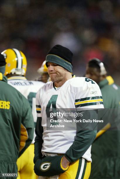 Green Bay Packers' quarterback Brett Favre looks down on himself after being lifted from play in the fourth quarter against the New York Jets at...