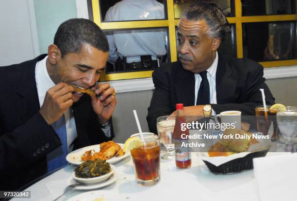 Democratic presidential candidate Sen. Barack Obama has a bite of fried chicken as he and The Rev. Al Sharpton have dinner at Sylvia's restaurant in...