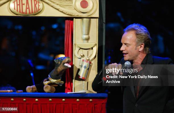 Sting is joined onstage by Triumph the Insult Comic Dog during "Singin' in the Rainforest," the 12th Rainforest Foundation Carnegie Hall Benefit...