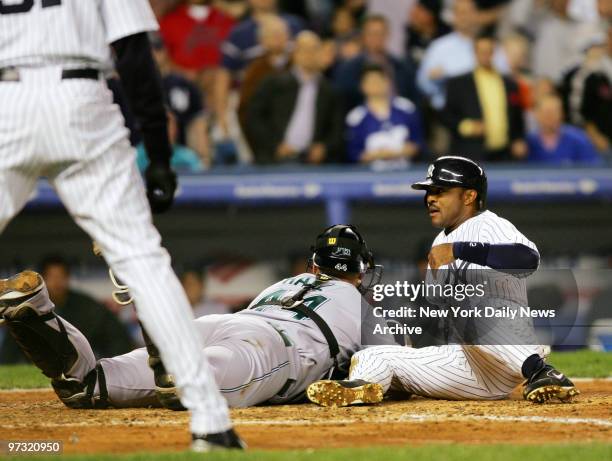 New York Yankees' Tony Womack slides into the tag of Tampa Bay Devil Rays' catcher Toby Hall for the third out while trying to score from first on a...
