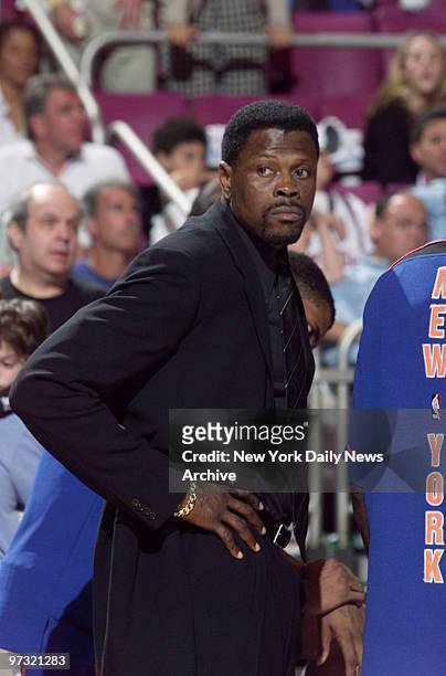 New York Knicks' Patrick Ewing, out with injuries, watches from the sidelines as his team plays the Indiana Pacers in the Eastern Conference finals...