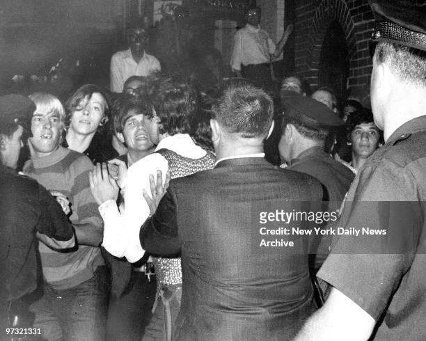 Stonewall Inn nightclub raid. Crowd attempts to impede police arrests outside the Stonewall Inn on Christopher Street in Greenwich Village.