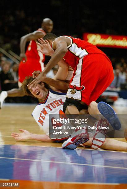 New York Knicks' Travis Knight is floored by Atlanta Hawks' Shareef Abdur-Rahim during game action at Madison Square Garden. The Hawks tried to run...
