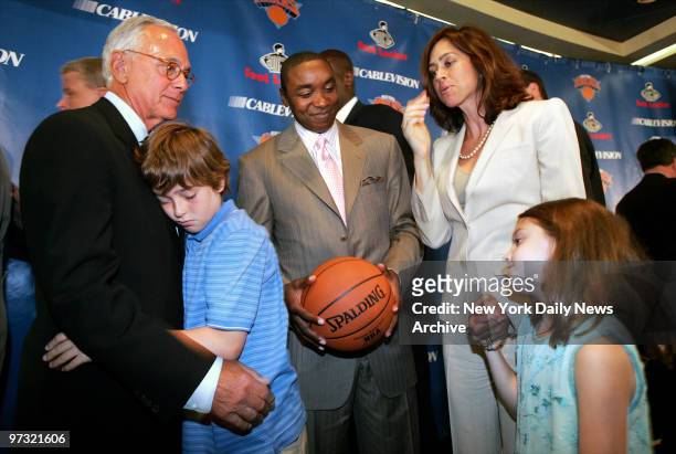 New York Knicks' president Isiah Thomas smiles as Larry Brown hugs his 11-year-old son, L.J., while Brown's wife, Shelly, and daughter Madison look...
