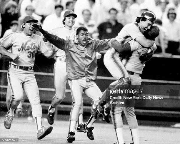 Mets' catcher Gary Carter leaps into the arms of pitcher Jesse Orosco after Orosco struck out Kevin Bass on a 3-2 pitch to end a 16 inning game and...
