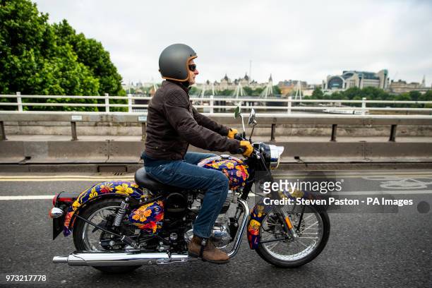 Jeremy Taylor riding the Dan Baldwin Royal Enfield bike over Waterloo Bridge during the photocall in London. PRESS ASSOCIATION Photo. Picture date:...