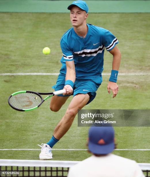 Rudolf Molleker of Germany plays a forehand lob over Lucas Pouille of France during day 3 of the Mercedes Cup at Tennisclub Weissenhof on June 13,...