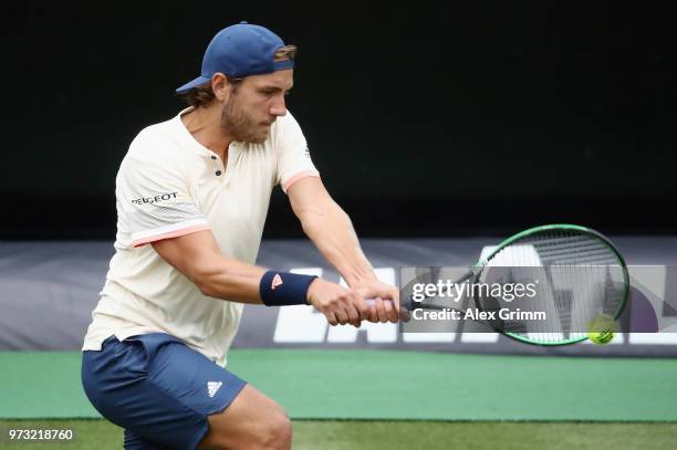 Lucas Pouille of France plays a backhand during his match against Rudolf Molleker of Germany during day 3 of the Mercedes Cup at Tennisclub...