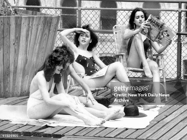 Upon the roof of a building on East 39th Street, models Michelle Mayfield, Feline Terrell, Regine Vavasseur, and Eileen Barker get an early start on...