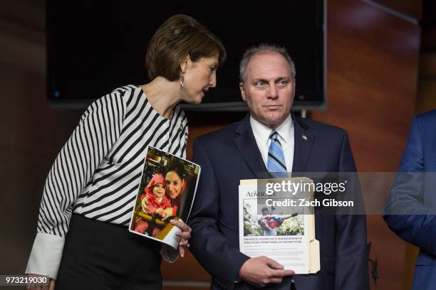 Rep. Cathy McMorris Rodgers , left, and House Majority Whip Steve Scalise, , holding a photographs of people who have been affected by the opioid...