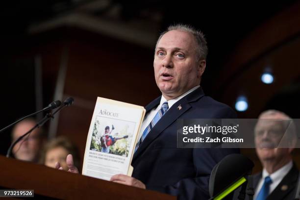 House Majority Whip Steve Scalise , holding an article featuring people who have been affected by the opioid epidemic, speaks during a news...