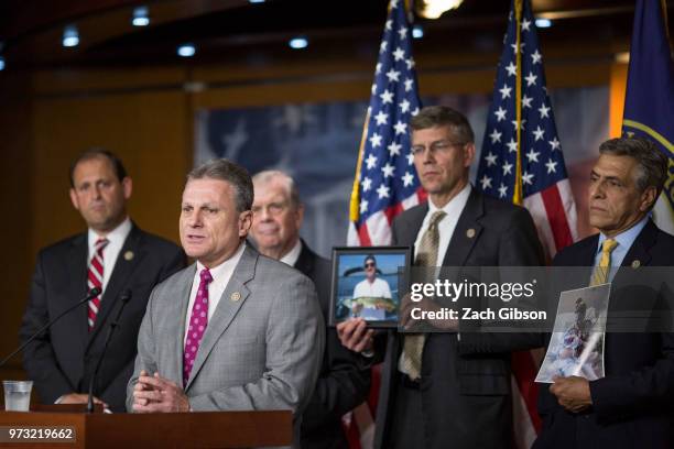 Rep. Buddy Carter speaks as photographs are held up of people affected by the opioid epidemic during a news conference following a Republican...