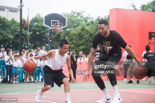 Player Ben Simmons of the Philadelphia 76ers plays basketball with children on June 13, 2018 in Guangzhou, China.