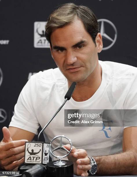 Roger Federer of Switzerland talks to the media after winning his match against Mischa Zverev of Germany during day 3 of the Mercedes Cup at...