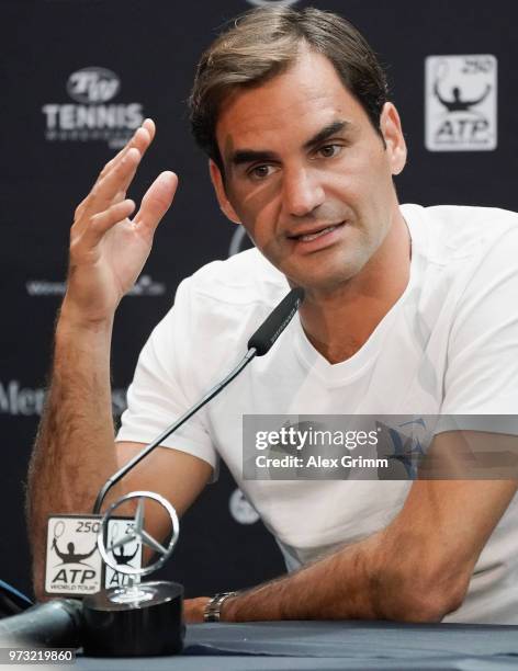 Roger Federer of Switzerland talks to the media after winning his match against Mischa Zverev of Germany during day 3 of the Mercedes Cup at...