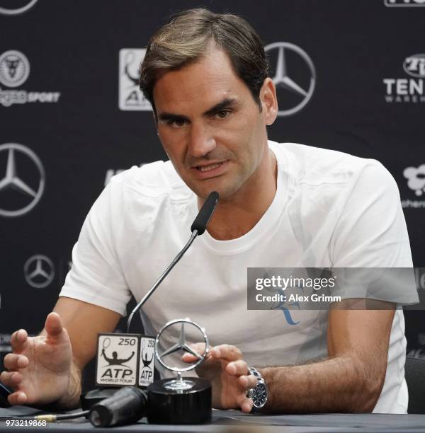 Roger Federer of Switzerland talks to the media after winning his match against Mischa Zverev of Germany during day 3 of the Mercedes Cup at...