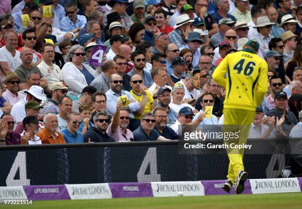 Cricket fans wave sandpaper four cards at Ashton Agar of Australia during the 1st Royal London ODI match between England and Australia at The Kia...