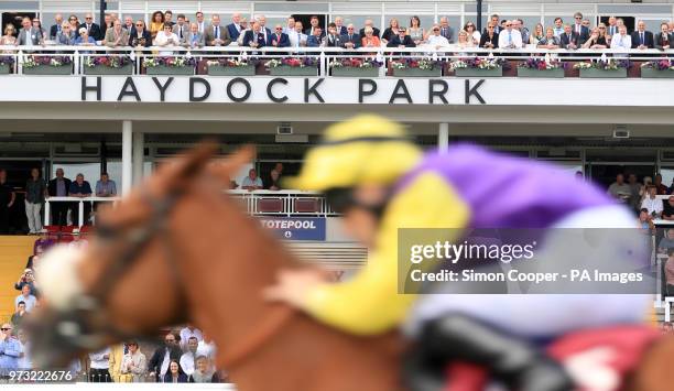 Racegoers look on as Humble Gratitude ridden by Ben Cutis wins The Play Live Blackjack at 188Bet Casino Handicap Stakes at Haydock Park Racecourse....