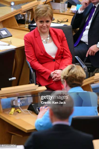 First Minister Nicola Sturgeon listens as Scottish Liberal Democrat Willie Rennie winds up a Liberal Democrat debate in the Scottish Parliament on...