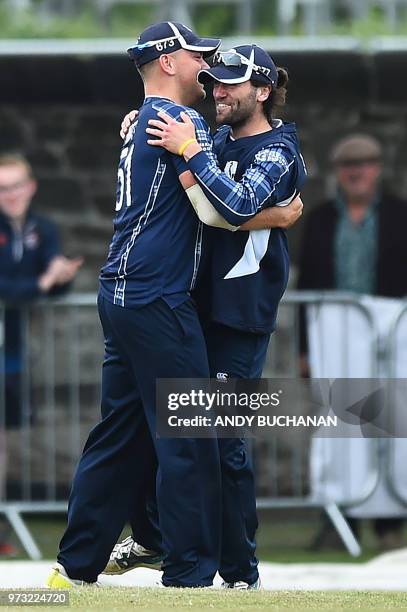 Scotland's Dylan Budge and Scotland's Mark Watt celebrate taking the wicket of Pakistan's Sarfraz Ahmed for 14 runs during the second Twenty20...