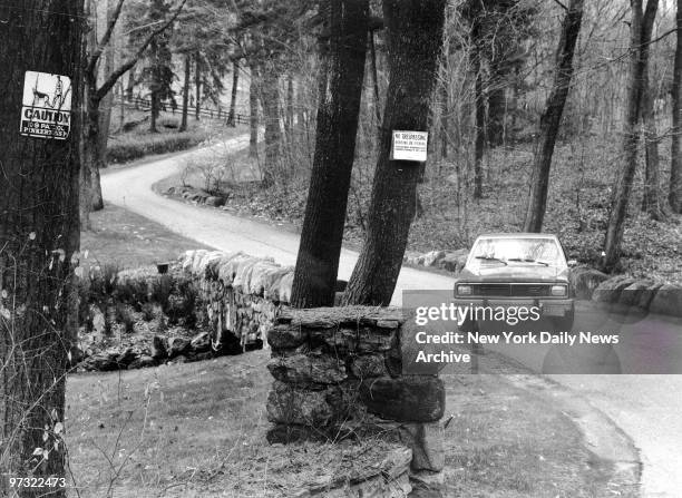 Guard sitting in car blocks driveway to Ivan Boesky residence. Signs tell the story, no trespassing and guard dog patroling. House is about a mile up...