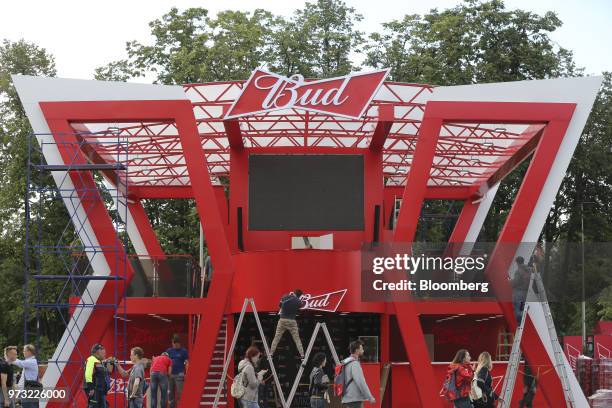 Workers prepare a promotional pavilion advertising Bud beer, manufactured by Anheuser-Busch InBev NV, during preparations ahead of the FIFA World Cup...