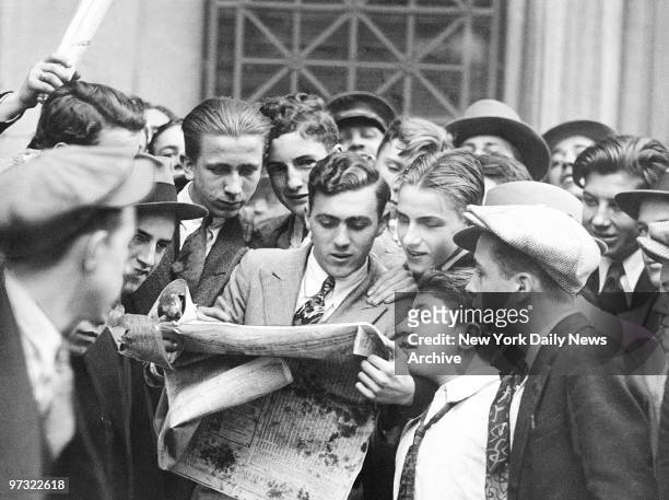 Messengers from brokerage houses seem unconcerned as they crowd around a hard-to-obtain newspaper after the first Wall Street stock market crash on...