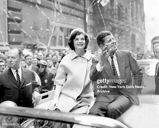 Democratic presidential nominee John F. Kennedy and his wife, Jacqueline, ride up Broadway in a ticker-tape parade.