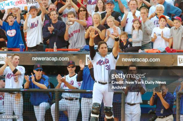 New York Mets' catcher Mike Piazza waves to fans during the seventh-inning stretch when a video tribute to him was shown at Shea Stadium. Piazza...