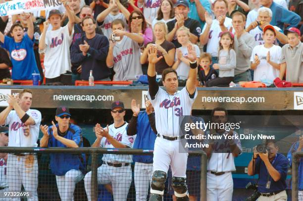 New York Mets' catcher Mike Piazza waves to fans during the seventh-inning stretch when a video tribute to him was shown at Shea Stadium. Piazza...