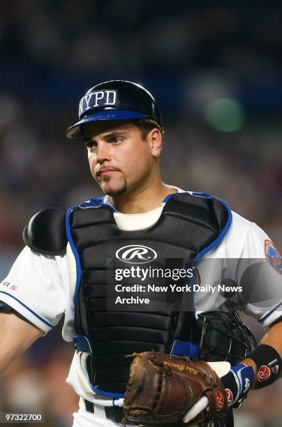 New York Mets' catcher Mike Piazza wears a New York City Police Department logo on his cap as he plays against the Atlanta Braves at Shea Stadium in...