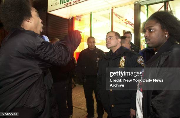 Kaamil Boman and Kayce Terrell, friends of Allen Newsom who was shot and killed by undercover police, confront officers outside Wimpy's restaurant at...