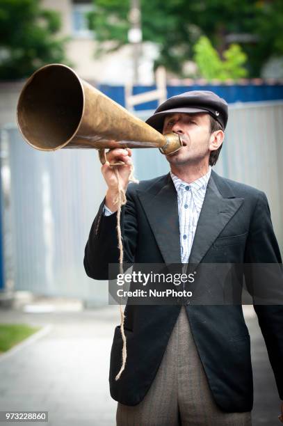 Man with an antique megaphone advertises the opening of the Polish Vodka Musuem on June 12, 2018 in Warsaw, Poland.