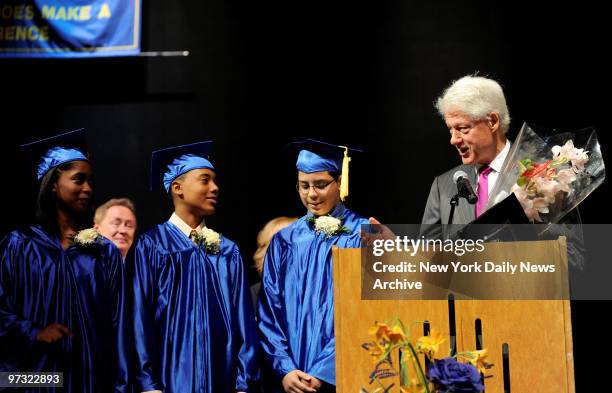 Students Dyonishia Miller-Nieves, Stanley Munoz and Daniel Rodriguez with former President Bill Clinton talks to graduates from the Mott Hall School...