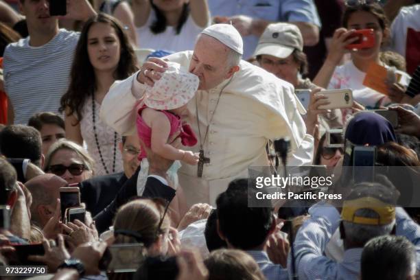 Pope Francis kissed the baby during the Weekly General Audience in St. Peter's Square.