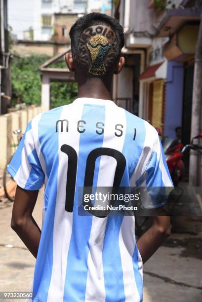 Indian Boy fan of Argentina soccerStar Lionel Messi and Hair stile a FIFA World Cup 2018 trophy on June 13,2018 Near of Kolkata City ,India .ahead of...