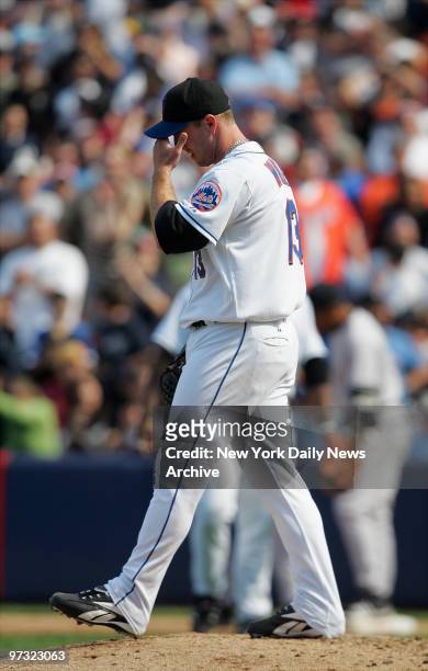 New York Mets' reliever Billy Wagner, who entered the game at the start of the ninth, holds his head after hitting New York Yankees' Bernie Williams...