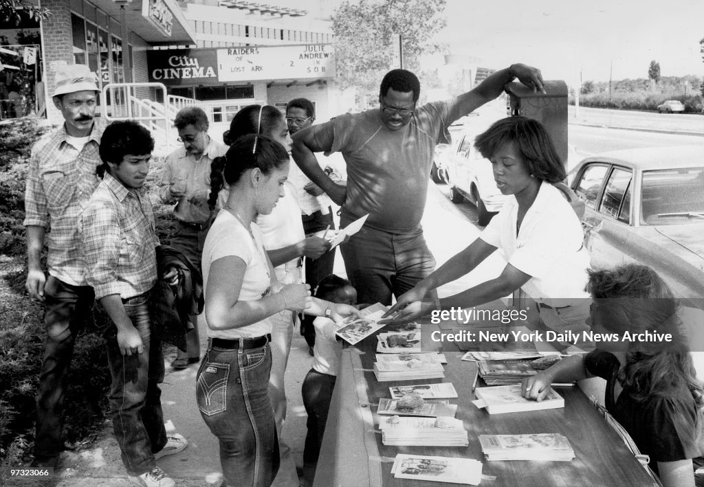 Students from Lehman College hand out information in Co-Op C