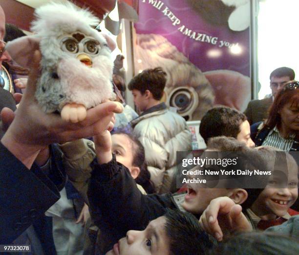 Students from PS 59 meet Furby, a new interactive toy, at FAO Schwarz.