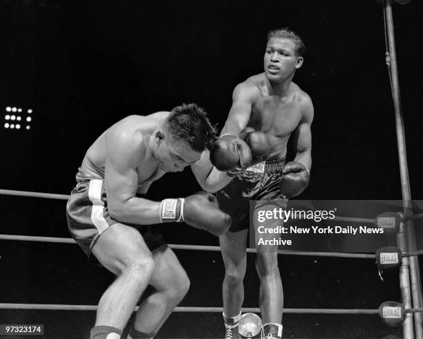 Sugar Ray Robinson connects with a right in the 12th round against Frenchman Robert Villemain at Philadelphia's Municipal Stadium.