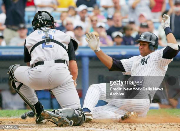 Kansas City Royals' catcher John Buck tags New York Yankees' Alex Rodriguez at home, without the ball, as A-Rod scores during the sixth inning at...