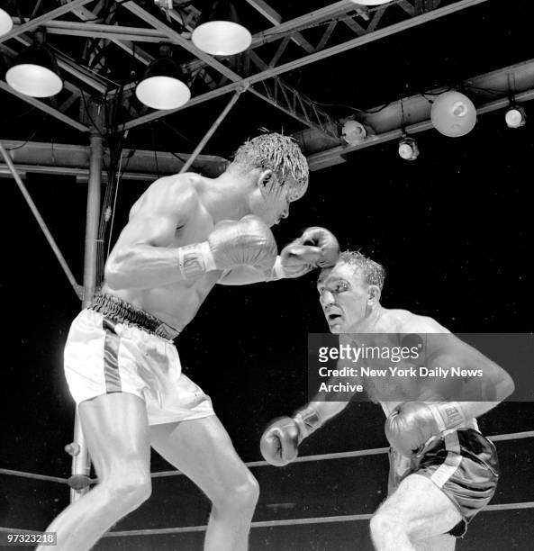 Sugar Ray Robinson trying to keep Carmen Basilio at bay during their middleweight bout at Yankee Stadium. Basilio won a 15-round split decision.