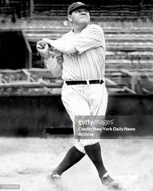 New York Yankees' Babe Ruth swinging his bat. Babe Ruth follows flight of one of his 46 home runs. Ruth\'s record-setting swats kept Yankee Stadium...