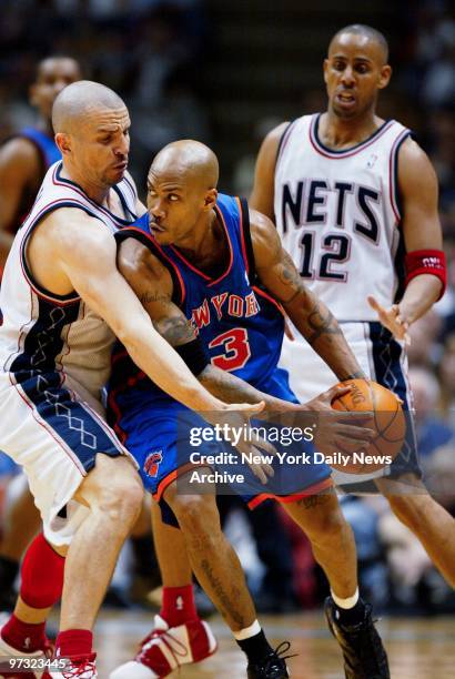 New York Knicks' Stephon Marbury tries to drive past New Jersey Nets' Jason Kidd as Nets' Lucious Harris looks on in the first half of first-round...