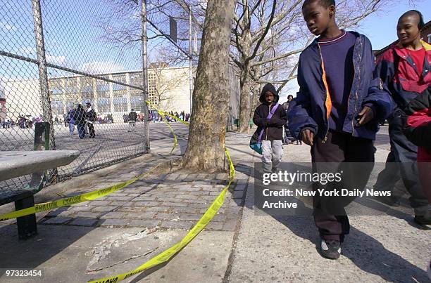 Students walking past Hattie Carthan Playground, outside Public School 305 in Bedford Stuyvesant, look at taped-off area where a police van crashed...