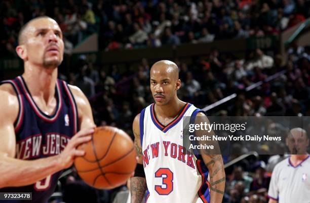 New York Knicks' Stephon Marbury watches as New Jersey Nets' Jason Kidd shoots a free throw in the second half of Game 4 of first-round playoffs at...