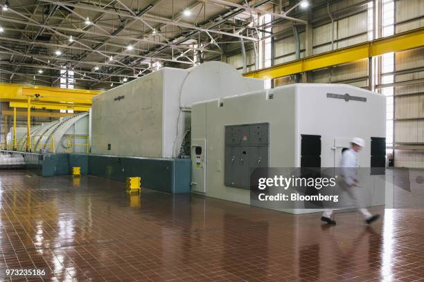 Worker walks through the lower level turbine room at the Exelon Corp. Three Mile Island nuclear power plant in Middletown, Pennsylvania, U.S., on...