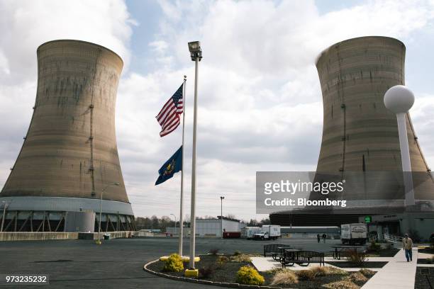 An American flag flies in front of cooling towers at the Exelon Corp. Three Mile Island nuclear power plant in Middletown, Pennsylvania, U.S., on...